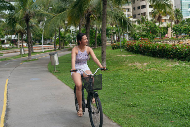 istock Woman riding a bicycle in the park 1349165244