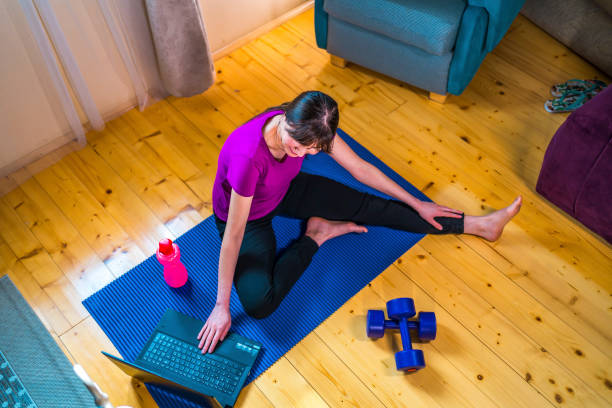 istock Sportswoman exercising at home 1349165800