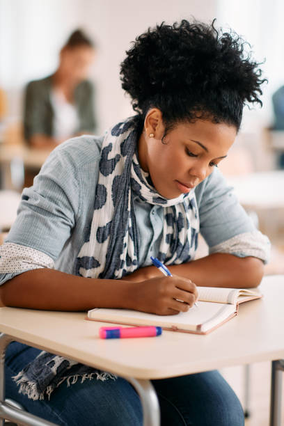 istock African American female student taking notes during a class at the university. 1349166905