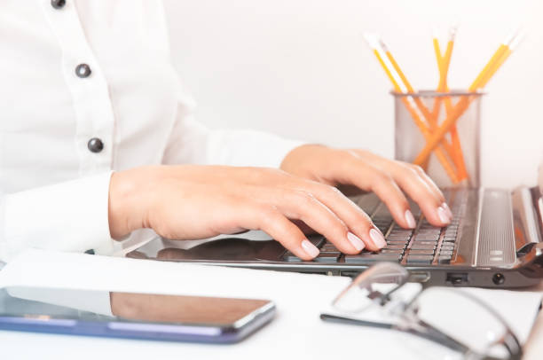 istock Female hands typing on a laptop keyboard 1349168387