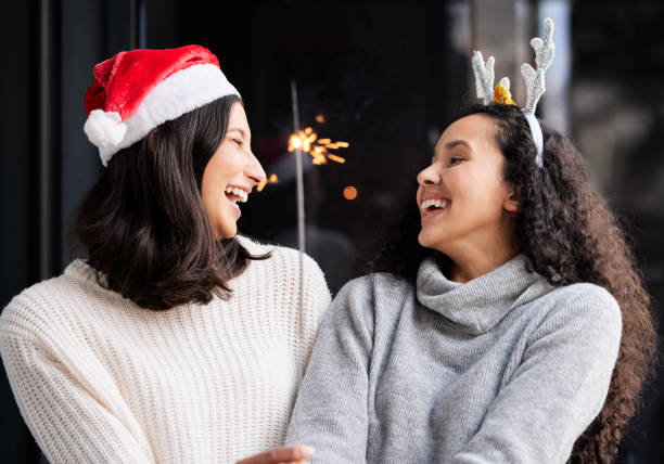 istock Shot of two friends using a sparkle stick ay home 1349172337
