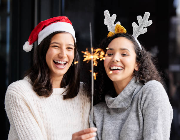 istock Shot of two friends using a sparkle stick ay home 1349172345