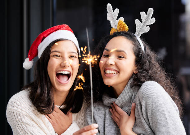 Shot of two friends using a sparkle stick ay home