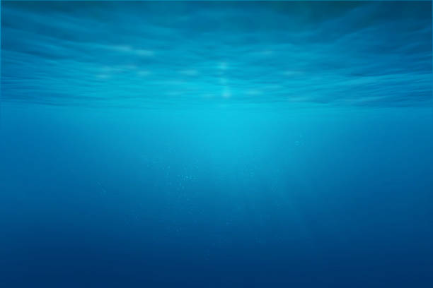 istock Blue sea or ocean underwater with synbeam and ripples. 1349173693