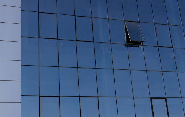 istock Closeup of glass windows building and one open window as a background 1349174309