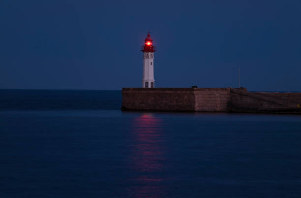 A Lighthouse with red light at night, Almeria, Spain