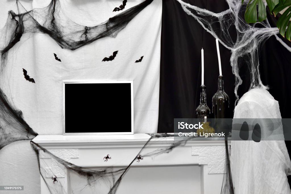 Halloween interior with fireplace, bats, ghost, candles and cobwebs. Holiday decor. Place for text Animal Body Part Stock Photo