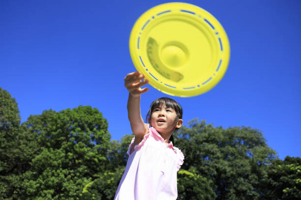 istock Japanese student girl playing flying disc (6 years old) 1349176879