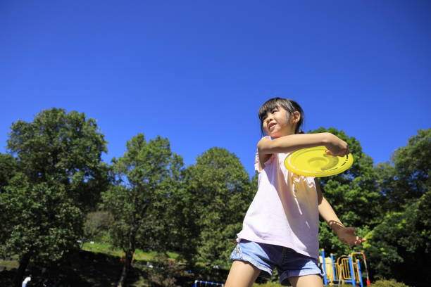 Japanese student girl playing flying disc (6 years old)