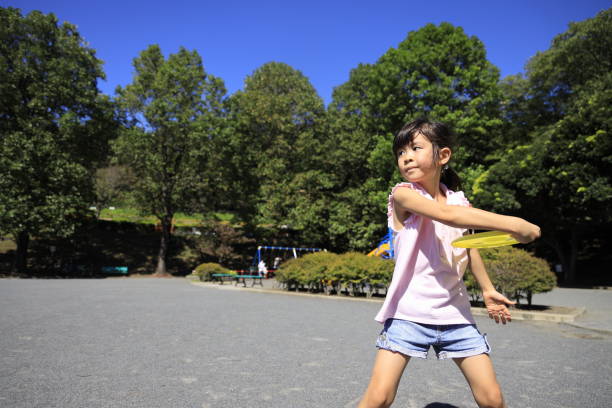 istock Japanese student girl playing flying disc (6 years old) 1349177035