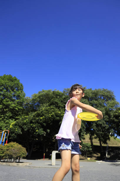istock Japanese student girl playing flying disc (6 years old) 1349177075