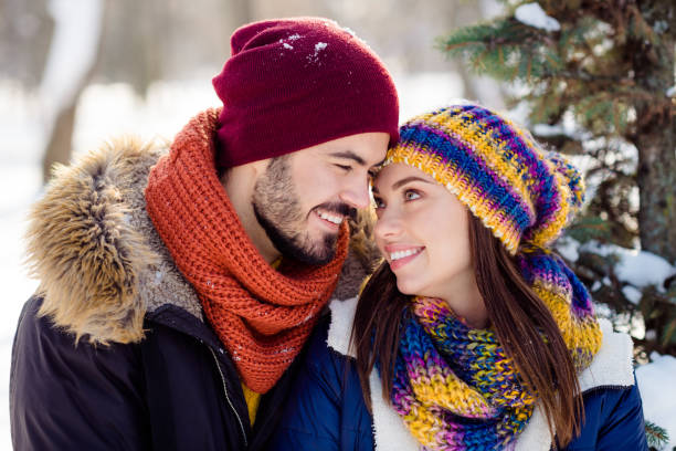 Photo of young attractive couple happy positive smile enjoy time together look each other love winter stock photo
