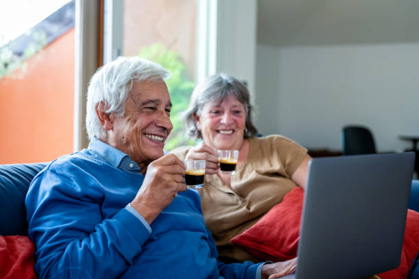 glückliches altes seniorenpaar mit laptop-computer mit videoanruf, ruhestand seniorenpaar lebensstil alter mit verbindungstechnologie, quarantänekonzept - coffee couple italy drinking stock-fotos und bilder