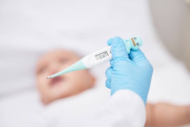 istock Shot of a unrecognizable doctor taking a babys temperature 1349179275