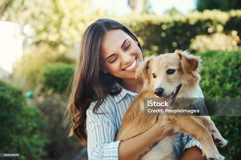 Shot of a young woman cuddling her dog This dog is my baby Dog Stock Photo