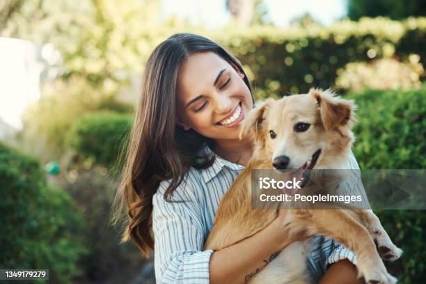 Shot Of A Young Woman Cuddling Her Dog Stock Photo - Download Image Now - Dog, Small, Outdoors