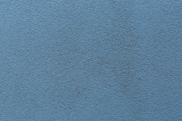 istock Sample of a texture of blue plaster. Wall finished with a decorative cement stucco. Example of exterior building decoration. Clean uniform grainy background. Banner. Wallpaper. Copy space. Pattern 1349181856
