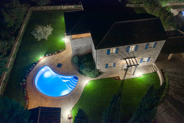 Luxurious beautiful modern villa with swimming pool and yard garden Luxurious beautiful modern villa with swimming pools and yard garden, aerial view by night, Istria, Croatia istria photos stock pictures, royalty-free photos & images