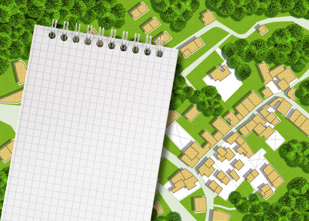 Imaginary cadastral map of territory with buildings, roads, land parcel and notepad with copy space