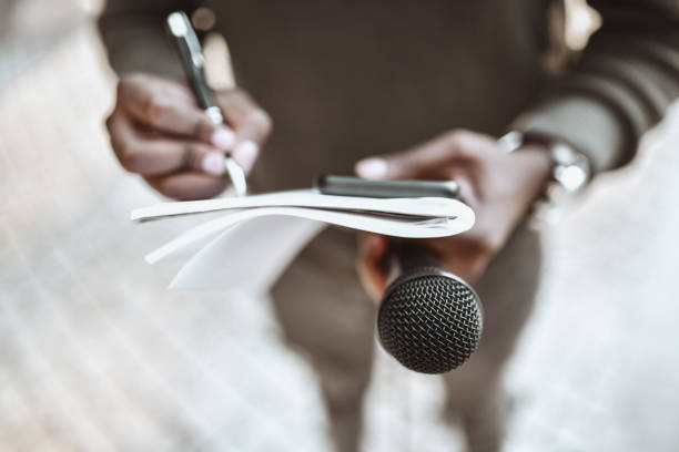African Male Journalist Preparing Questions For Press Conference stock photo