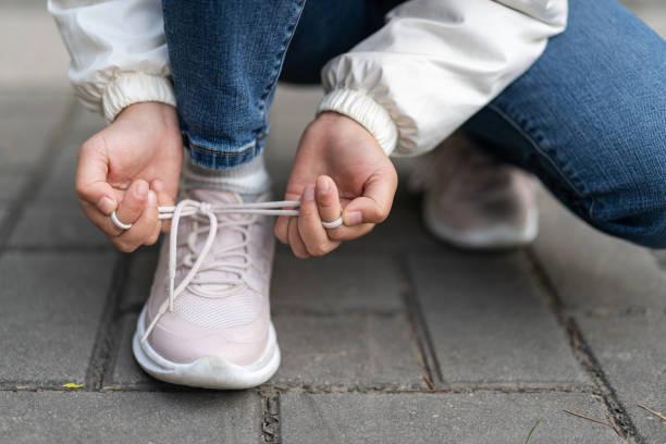 istock Child tying shoelace 1349183080