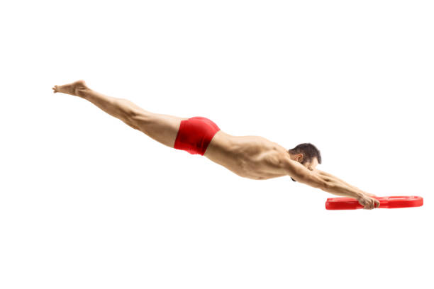 Male swimmer jumping and holding a swimming float isolated on white background