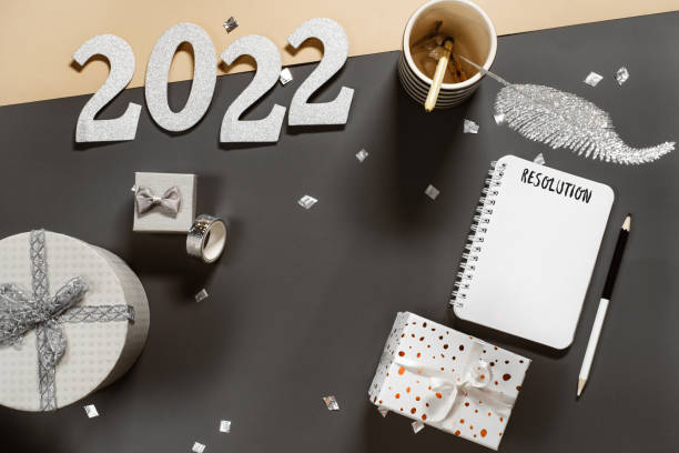 istock Opened note book for New Year lists on dark desk with gift 1349186262