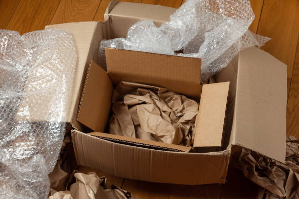 istock Cardboard boxes with crumpled wrapping paper and bubble pack 1349186349