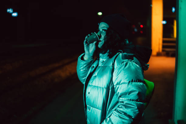 istock Young woman waiting on train station 1349187096