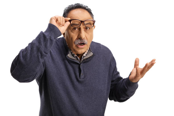 istock Confused mature man holding his glasses and gesturing with hand 1349187510