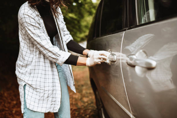 istock Focused Female Wiping Car Door Handle And Sanitizing Them 1349187512