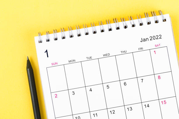 istock January 2022 desk calendar on yellow background. 1349188474