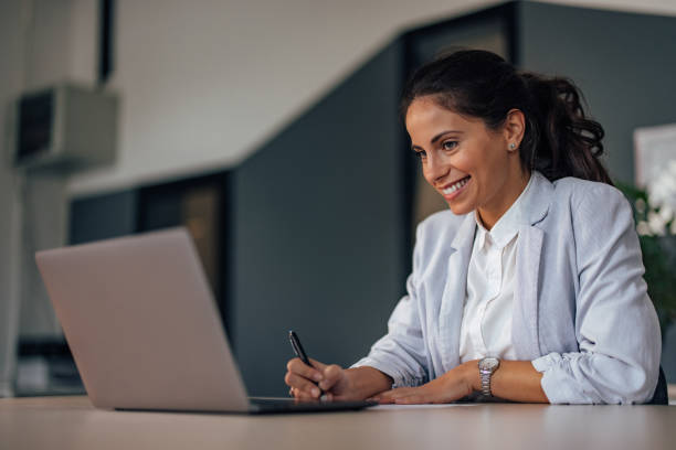 istock Adult woman, copying a document on paper. 1349190458