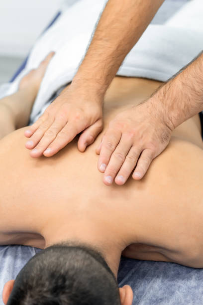 istock osteopath gives back massage to man 1349191381