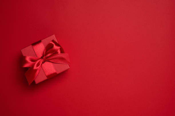 istock Christmas, Valentine Day or Anniversary red gift box decorated with red satin bow 1349191423