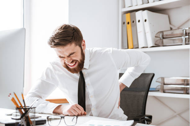 istock Businessman with painful feelings holding his back. 1349191664