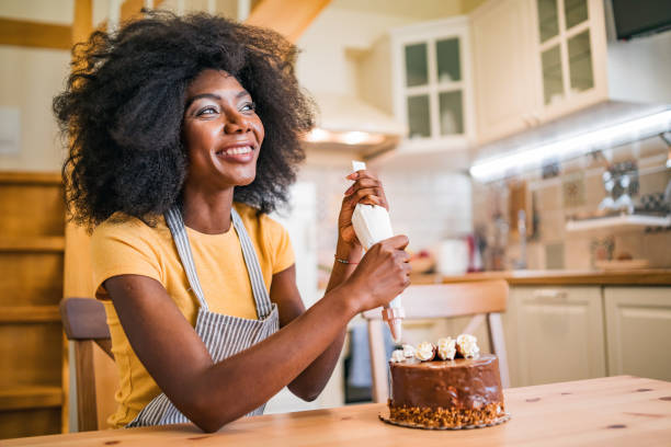 istock Afro women decorating a cake at home 1349191945