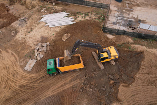 istock Excavator load the sand into dump truck. Loader digging ground for foundation pit. Earthmoving at construction site. 1349193449
