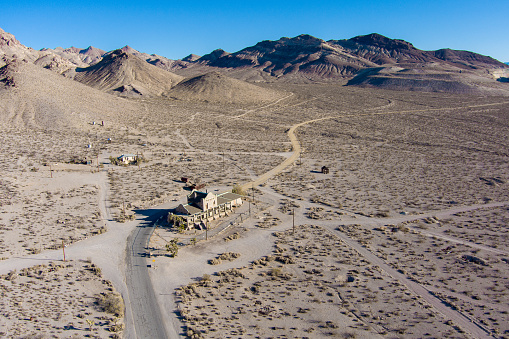 Aerial view of the abandoned ruins of Rhyolite mining camp in the Nevada desert. This Ghost town sits just outside the entrance to Death Valley National Park.