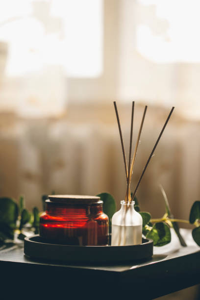 istock Romantic aromatherapy sticks and decorative tree branch in beautiful dark evening light for events. Design element. Candles, romance, love, spa, relaxation 1349196698