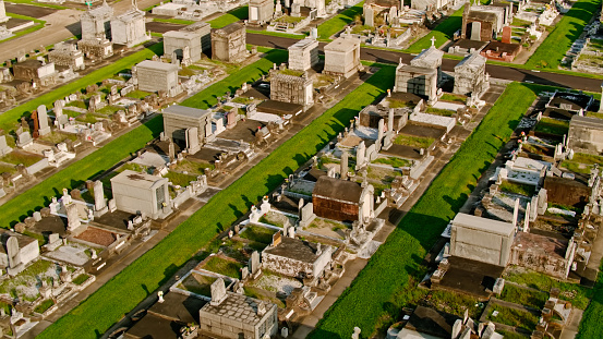 Aerial shot of New Orleans, Louisiana on a summer afternoon, looking down on the rows of above ground tombs in cemeteries of the Navarre neighborhood.