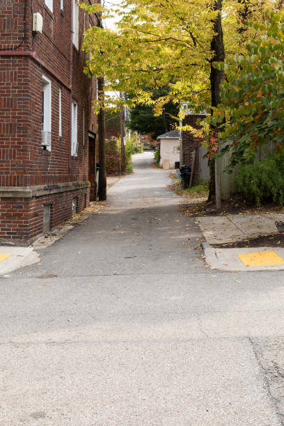istock Long alleyway alongside a red brick apartment building, creative copy space 1349199186
