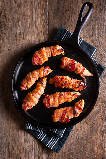 Bacon-Wrapped Chicken Tenderloins on a Cast Iron Griddle