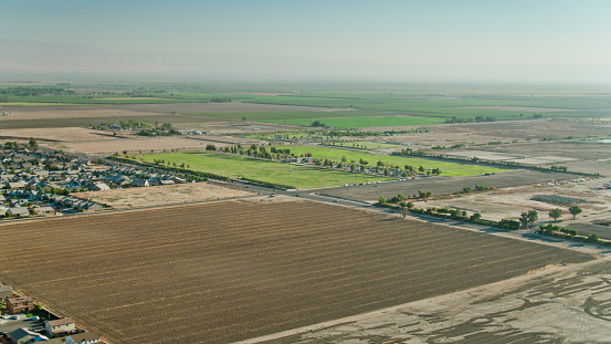 Drone shot of the southern edge of Bakersfield, California, where Central Valley farmland gives way to residential streets. \n\nAirspace authorization was obtained from the FAA for this operation.