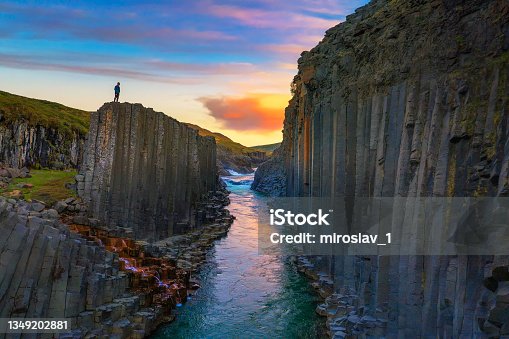 istock Hiker standing at the top of Studlagil Canyon in Iceland at sunset 1349202881