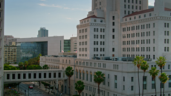Aerial shot of Los Angeles City Hall and the Los Angeles Police Department Headquarters in Downtown Los Angeles at sunset.