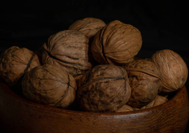 istock Walnuts with wooden bowl 1349203333