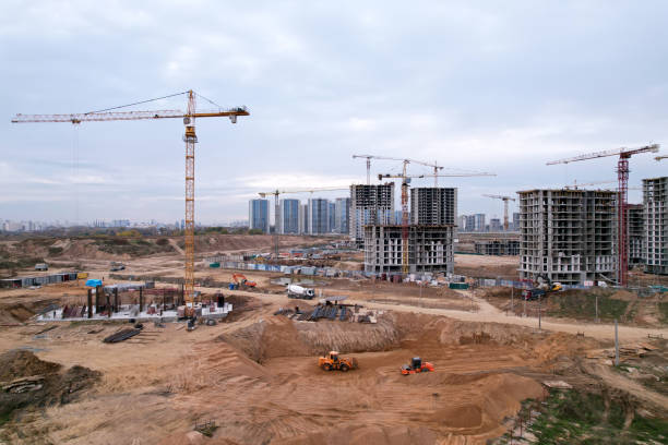 istock Tower crane at buildings construction. Soil Compactor at construction site. 1349203822