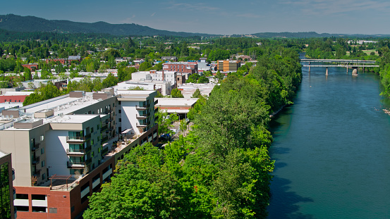 Aerial shot of the Willamette River flowing past Corvallis, Oregon on a hot and sunny day in summer.