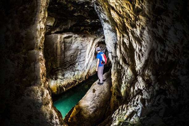 istock Man exploring smale cave with water in national park Rosandra 1349208960
